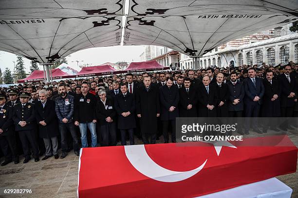 Turkish president Recep Tayyip Erdogan and former Prime minister Ahmet Davutoglu attend the funeral of Turkish police officer Hasim Usta, who was...