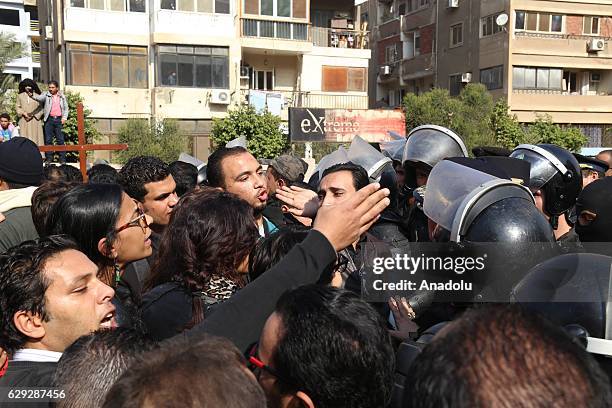 Security forces intervene people during the funeral ceremony for the victims of the explosion at Saint Peter and Saint Paul Coptic Orthodox Church in...