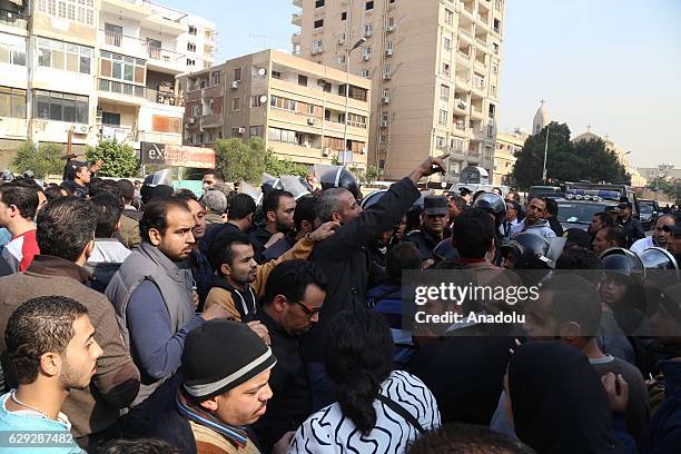 Security forces intervene people during the funeral ceremony for the victims of the explosion at Saint Peter and Saint Paul Coptic Orthodox Church in...