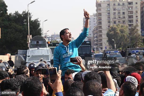 People react during the funeral ceremony for the victims of the explosion at Saint Peter and Saint Paul Coptic Orthodox Church in Abbasiya district,...