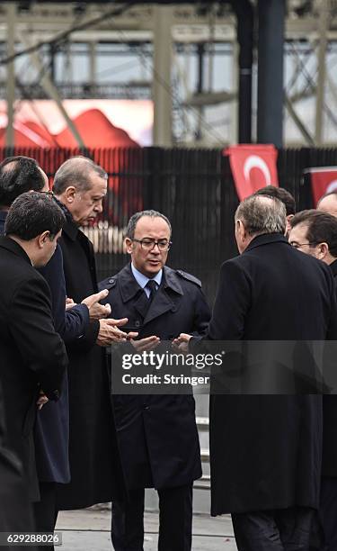 Turkish President Recep Tayyip Erdogan prays as he visits the blast site outside the Besiktas FC's Vodafone Arena Stadium on December 12, 2016 in...