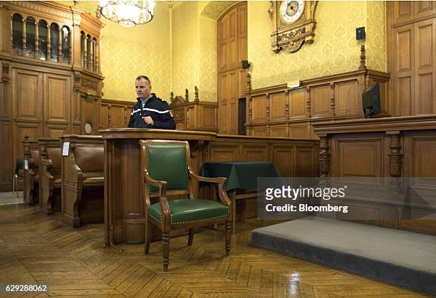 Police officer checks the courtroom seating area ahead of the trial of Christine Lagarde, managing director of the International Monetary Fund ,...
