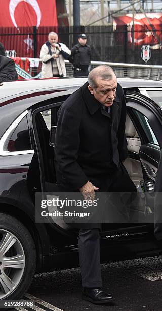 Turkish President Recep Tayyip Erdogan leaves his motocade during his visit the blast site outside the Besiktas FC's Vodafone Arena Stadium on...