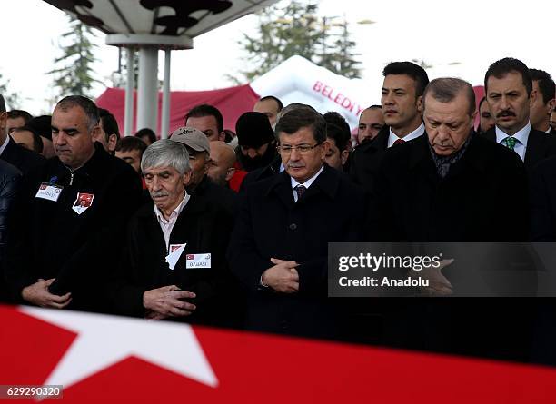 Turkish President Recep Tayyip Erdogan and Turkey's Former Prime Minister Ahmet Davutoglu attend the funeral ceremony of martyred policeman Hasim...