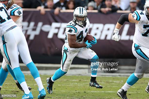 Fozzy Whittaker of the Carolina Panthers runs with the ball during the game against the Oakland Raiders at the Oakland-Alameda County Coliseum on...