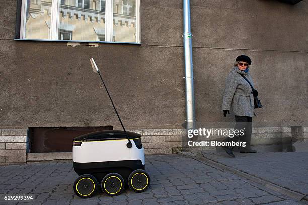 Bloomberg Best of the Year 2016: A pedestrian does a double take as a prototype self driving parcel delivery robot, developed by Starship...