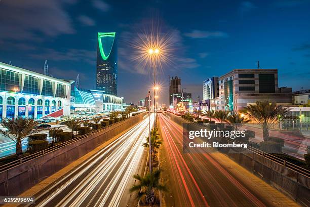 Bloomberg Best of the Year 2016: The Kingdom Tower, operated by Kingdom Holding Co., left, stands alongside the King Fahd highway, illuminated by the...