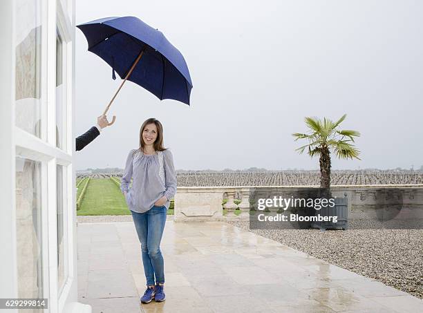 Bloomberg Best of the Year 2016: Caroline Frey, a winemaker, is sheltered under an umbrella as she poses for a photograph at Chateau La Lagune in...