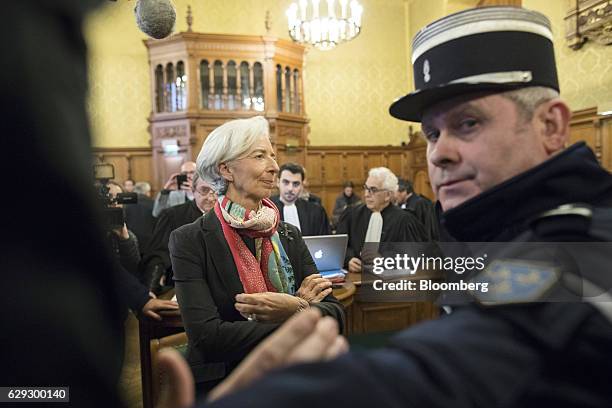 Christine Lagarde, managing director of the International Monetary Fund , center, stands inside the courtroom on the opening day of her trial at the...