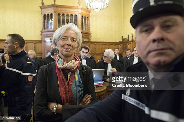 Christine Lagarde, managing director of the International Monetary Fund , center, stands inside the courtroom on the opening day of her trial at the...