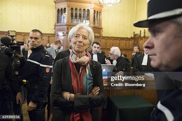 Christine Lagarde, managing director of the International Monetary Fund , center, stands inside the courtroom on the opening day of her trial at the...