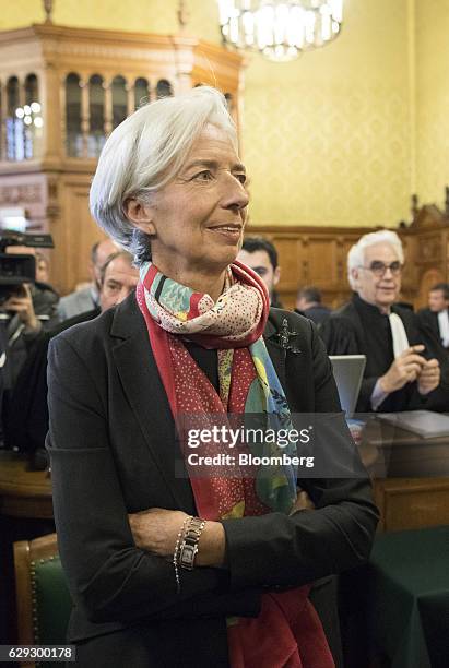 Christine Lagarde, managing director of the International Monetary Fund , stands inside the courtroom on the opening day of her trial at the Palais...