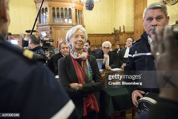 Christine Lagarde, managing director of the International Monetary Fund , center, stands inside the courtroom on the opening day of her trial at the...