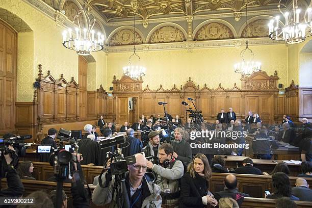 Television crews and members of the media leave the courtroom after photographing the arrival of Christine Lagarde, managing director of the...