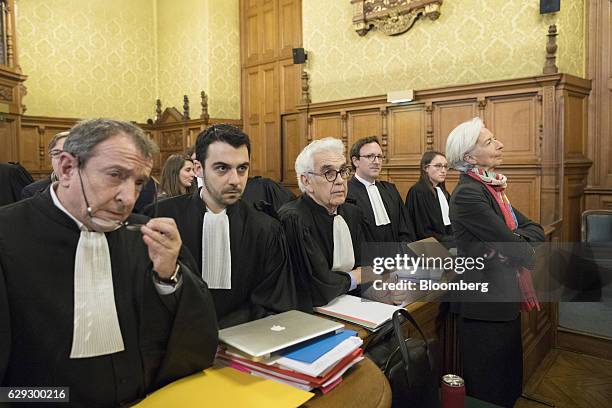 Christine Lagarde, managing director of the International Monetary Fund , right, stands inside the courtroom and next to Patrick Maisonneuve, a...