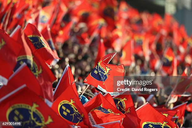 Munster fans wave their flags during the European Champions Cup match between Munster and Leicester Tigers at Thomond Park on December 10, 2016 in...