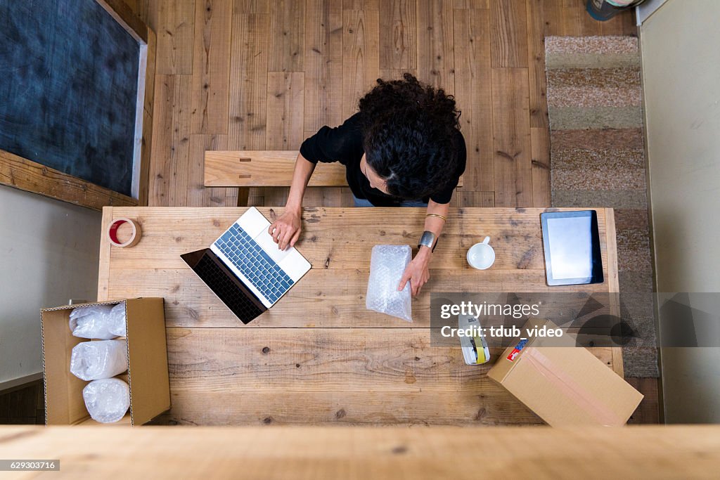 Aerial view of a woman wrapping products