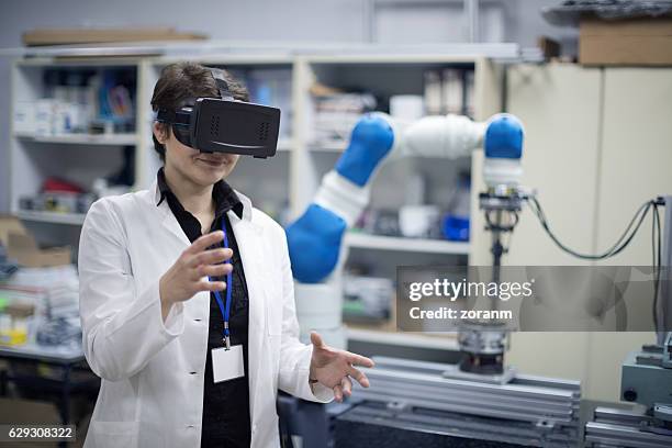 trying virtual reality simulator glasses in lab - simulation lab stock pictures, royalty-free photos & images