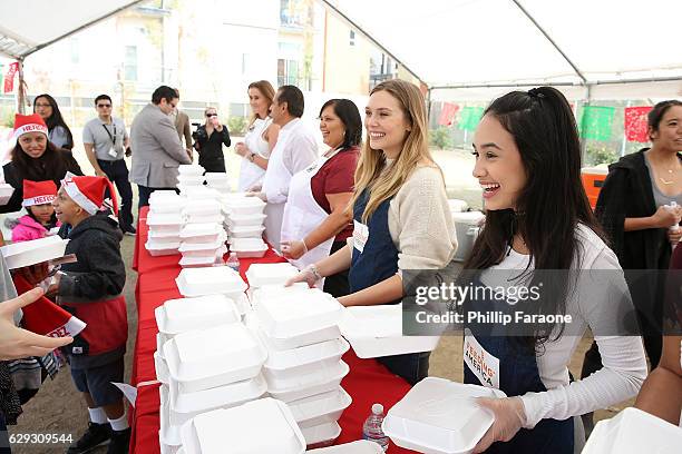 Elizabeth Olsen and Emily Tosta attend the Feeding America & LA Regional Food Bank Host "Hope For The Holidays" Celebrity Volunteer Event at Para Los...