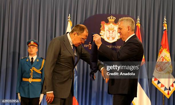 Serbia's President Tomislav Nikolic awards Russia's Foreign Minister Sergei Lavrov an 1st Class Order of the Serbian Flag after their meeting at the...