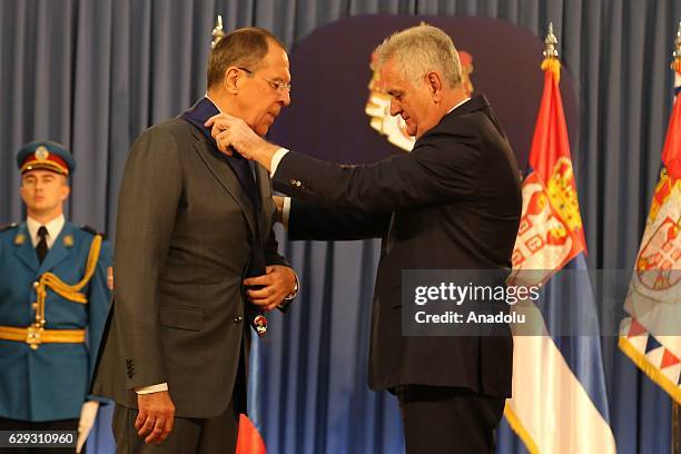 Serbia's President Tomislav Nikolic awards Russia's Foreign Minister Sergei Lavrov an 1st Class Order of the Serbian Flag after their meeting at the...