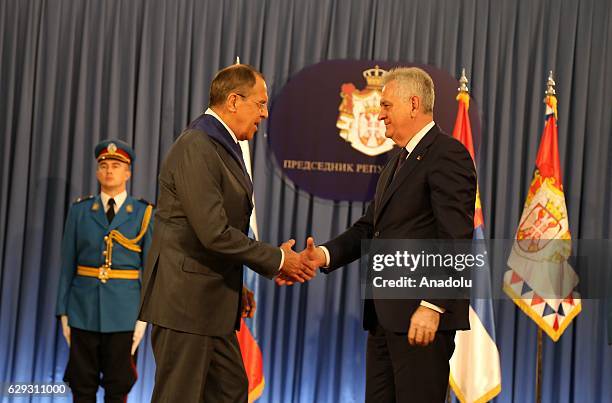 Serbia's President Tomislav Nikolic and Russia's Foreign Minister Sergei Lavrov shake hands during award ceremony of 1st Class Order of the Serbian...