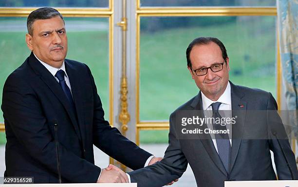 Riad Hijab, chief coordinator of the Syrian opposition's High Negotiations Committee , shakes hand with French President Francois Hollande after a...