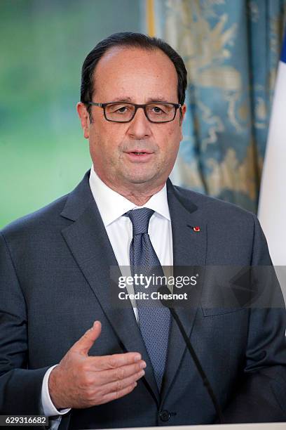 French President Francois Hollande delivers a speech next to Riad Hijab, chief coordinator of the Syrian opposition's High Negotiations Committee...