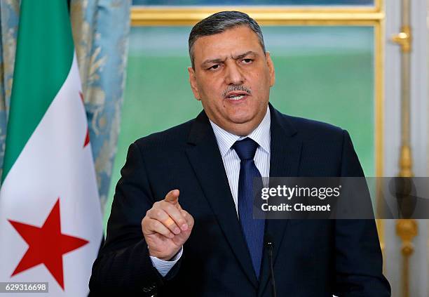 Riad Hijab, chief coordinator of the Syrian opposition's High Negotiations Committee , delivers a speech during a press conference with French...