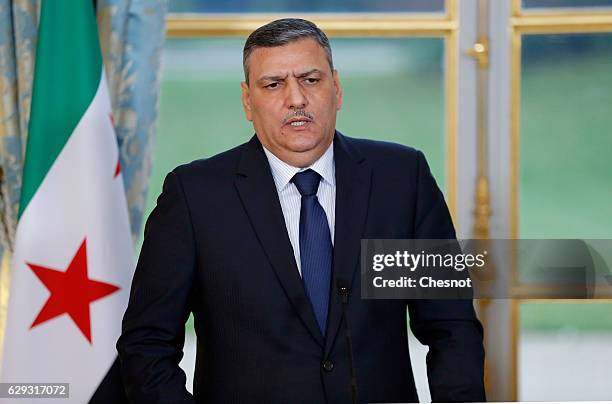 Riad Hijab, chief coordinator of the Syrian opposition's High Negotiations Committee , delivers a speech during a press conference with French...