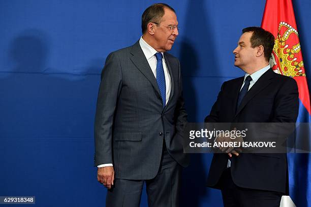 Russian Foreign Minister Sergey Lavrov talks to his Serbian counterpart Ivica Dacic prior to a press conference following their meetingin Belgrade on...