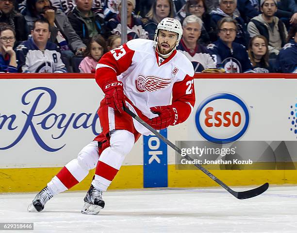 Brian Lashoff of the Detroit Red Wings keeps an eye on the play during first period action against the Winnipeg Jets at the MTS Centre on December 6,...
