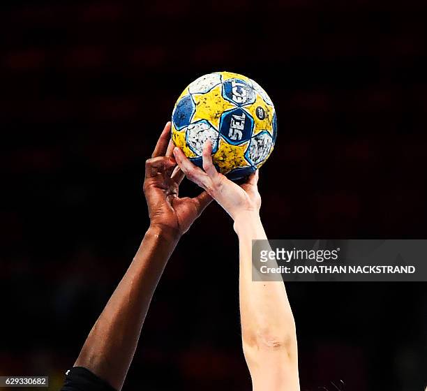 The hands of Spain's Alexandrina Cabral and Germany's Anna Loerper reach to grab the ball during the Women's European Handball Championship Group I...