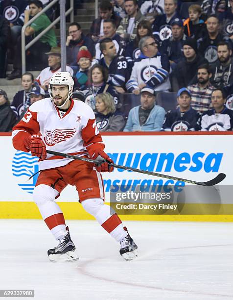 Brian Lashoff of the Detroit Red Wings keeps an eye on the play during first period action against the Winnipeg Jets at the MTS Centre on December 6,...