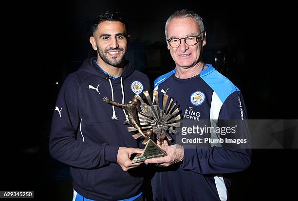 Riyad Mahrez receives the African Footballer of the Year from manager Claudio Ranieri at Belvoir Drive Training Complex on December 12, 2016 in...