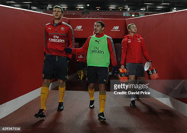 Krystian Bielik and Ismael Bennacer of Arsenal walk out to warm up before the Premier League match between Arsenal and Stoke City at Anfield on...
