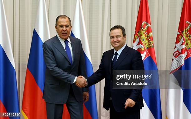 Russia's Foreign Minister Sergei Lavrov and his Serbian counterpart Ivica Dacic shake hands after their meeting, including bilateral agreements in...