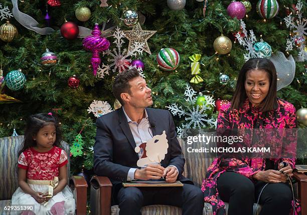 First Lady Michelle Obama and television personality Ryan Seacrest speak after reading "Twas The Night Before Christmas" to children at the...