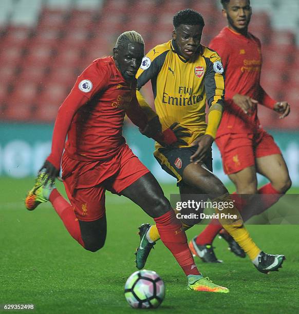 Stephy Mavididi of Arsenal takes on Mamadou Sakho of Liverpool during the Premier League match between Arsenal and Stoke City at Anfield on December...