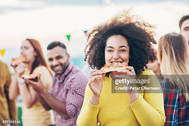 party with pizza - biting stock pictures, royalty-free photos & images