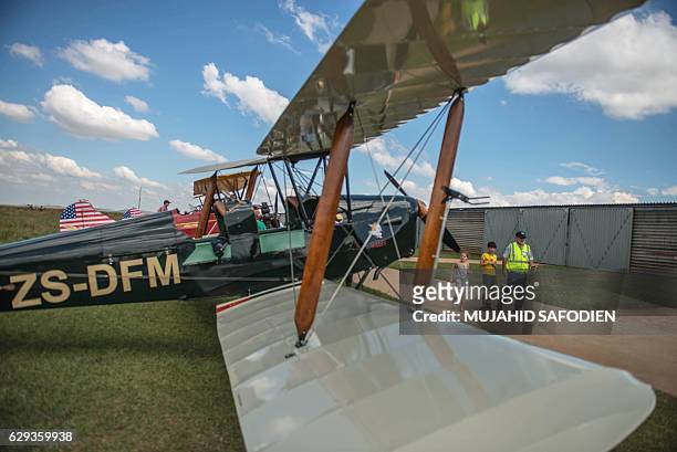 People look at aircrafts after they landed at Baragwanath airfield as part of the Vintage Air Rally airshow. A dozen biplanes from the 1920s and...