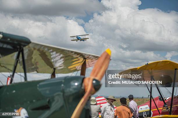 Picture taken on December 12, 2016 shows an aircraft flying over the Baragwanath airfield as part of the Vintage Air Rally airshow. A dozen biplanes...
