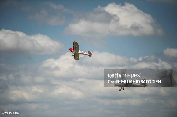 Picture taken on December 12, 2016 shows aircrafts flying over the Baragwanath airfield as part of the Vintage Air Rally airshow. - A dozen biplanes...
