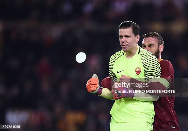 Roma's goalkeeper from Poland Wojciech Szczesny is congratulayted by Roma's midfielder from Italy Daniele De Rossi after saving a penalty during the...