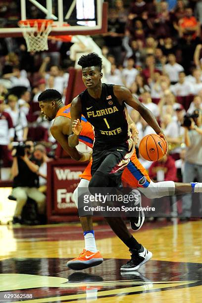 Jonathan Isaac forward Florida State University Seminoles brings the basketball across mid-court against the Florida Gators in the Sunshine Shootout...