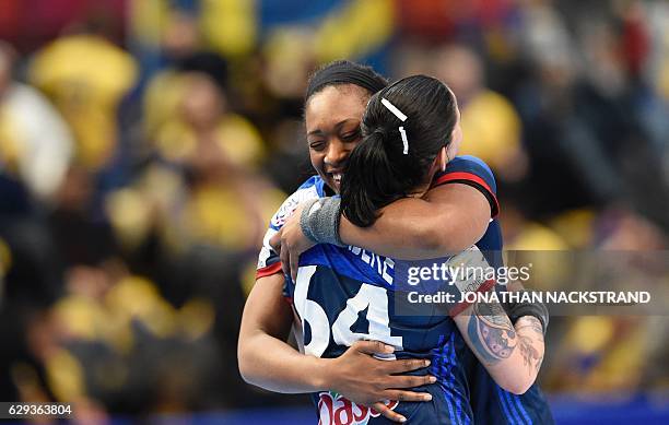 France's Alexandra Lacrabere and her teammate Siraba Dembele celebrate after the Women's European Handball Championship Group I match between Sweden...