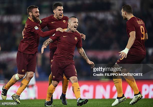 Roma's midfielder from Belgium Radja Nianggolan celebrates with teammates after scoring during the Italian Serie A football match Roma vs AC Milan at...
