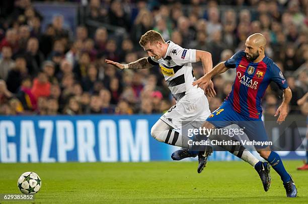 Andre Hahn of Borussia Moenchengladbach and Javier Mascherano of FC Barcelona battle for the ball during the UEFA Champions League match between FC...