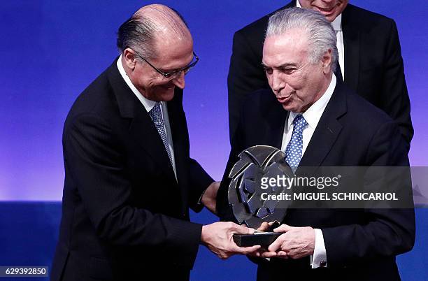 Brazil's President Michel Temer receives from Sao Paulo's governor Geraldo Alckmin the 2016 Brazil Leader Award, at the Bandeirantes governmental...