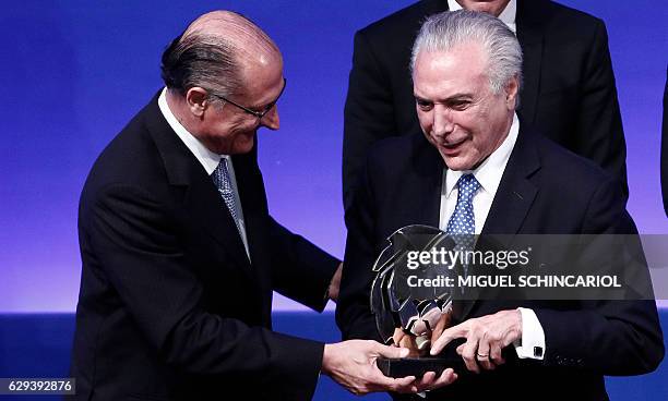 Brazil's President Michel Temer receives from Sao Paulo's governor Geraldo Alckmin the 2016 Brazil Leader Award, at the Bandeirantes governmental...